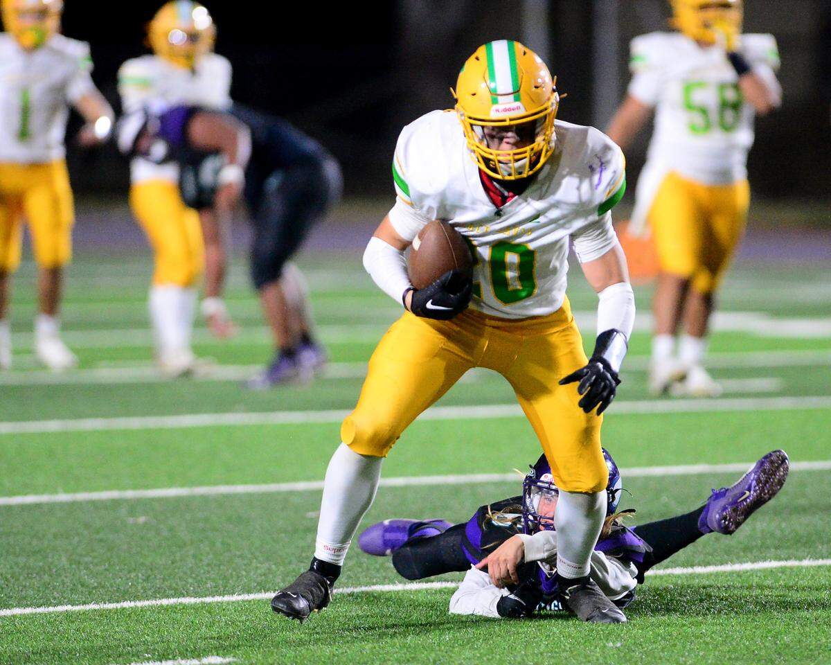 Davis receiver Lincoln Brooks (20) breaks a tackle after making a catch during a game between Johansen and Davis at Johansen High School in Modesto California on November 1, 2024.