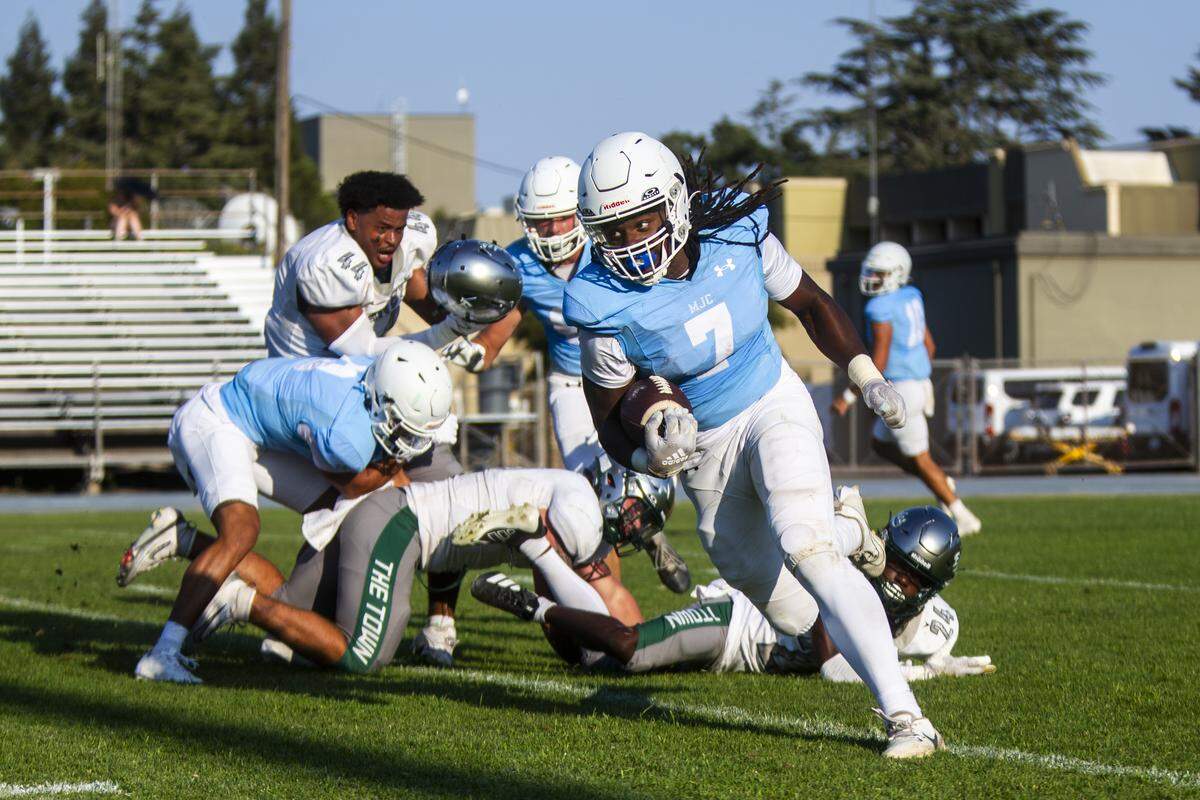 MJC running back Bryson Davis, 7, runs the ball upfield during the first half of a nonconference game against Laney College at Modesto Junior College on Saturday, Aug. 30, 2025.