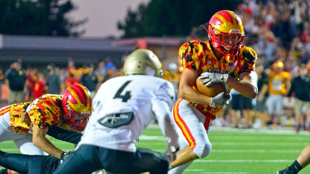 Oakdale running back Kevin Camelin (13) runs in for a touchdown during a football game between Oakdale High School and Archbishop Mitty High School at Oakdale High School in Oakdale California on September 10, 2021.