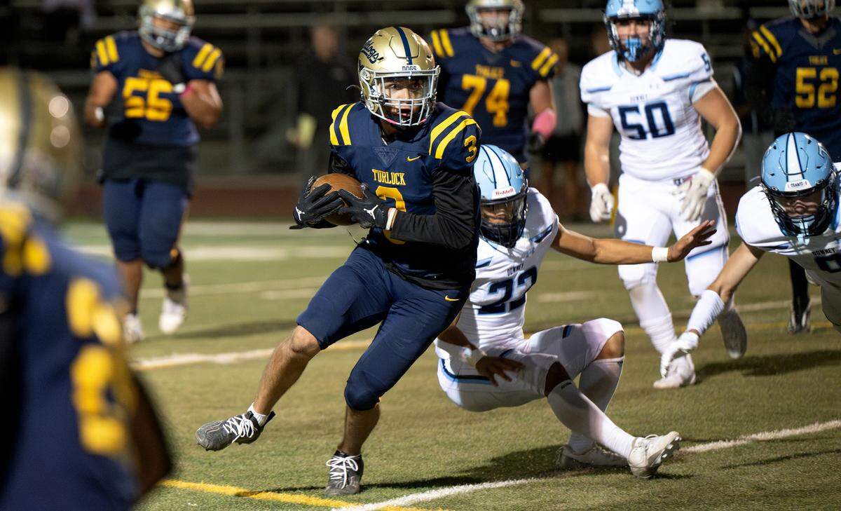 Turlock’s Leo Contreras slips a tackle during the Central California Athletic League game with Downey at Turlock High School in Turlock, Friday, Oct. 18, 2024.