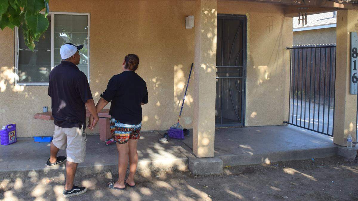 Gregorio Callejas and Felipa Flores stand in front of their new home in west Modesto on August 17, 2021. The family of seven were displaced from their home earlier this year.