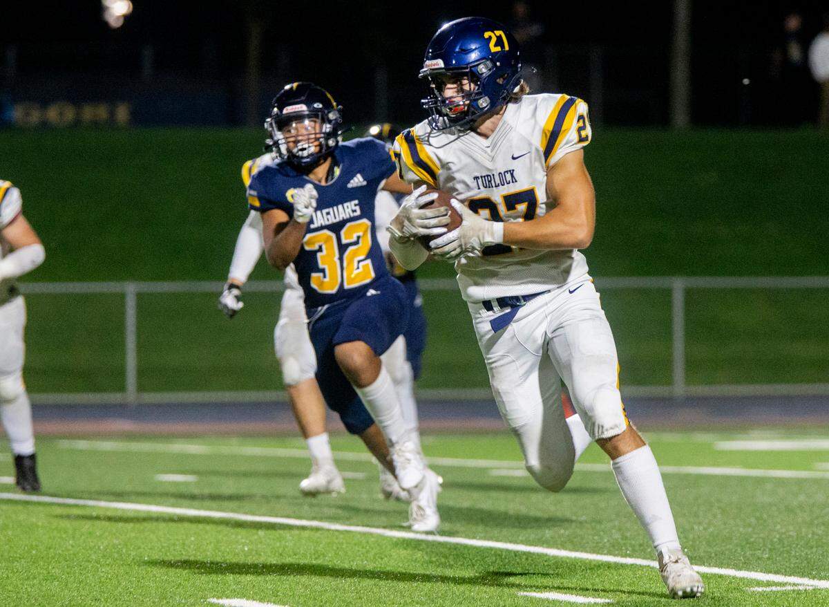 Brayden Green, 27, of Turlock High works his way upfield with Avyn Redoble, 32, of Gregori High closing in on him Thursday Sept. 28, 2023.