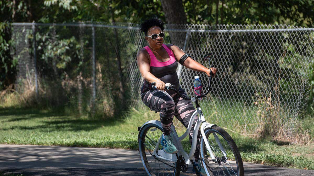 Shirrelle Mmasi rides her bicycle at East La Loma Park in Modesto, Calif., on Tuesday, July 28, 2020.