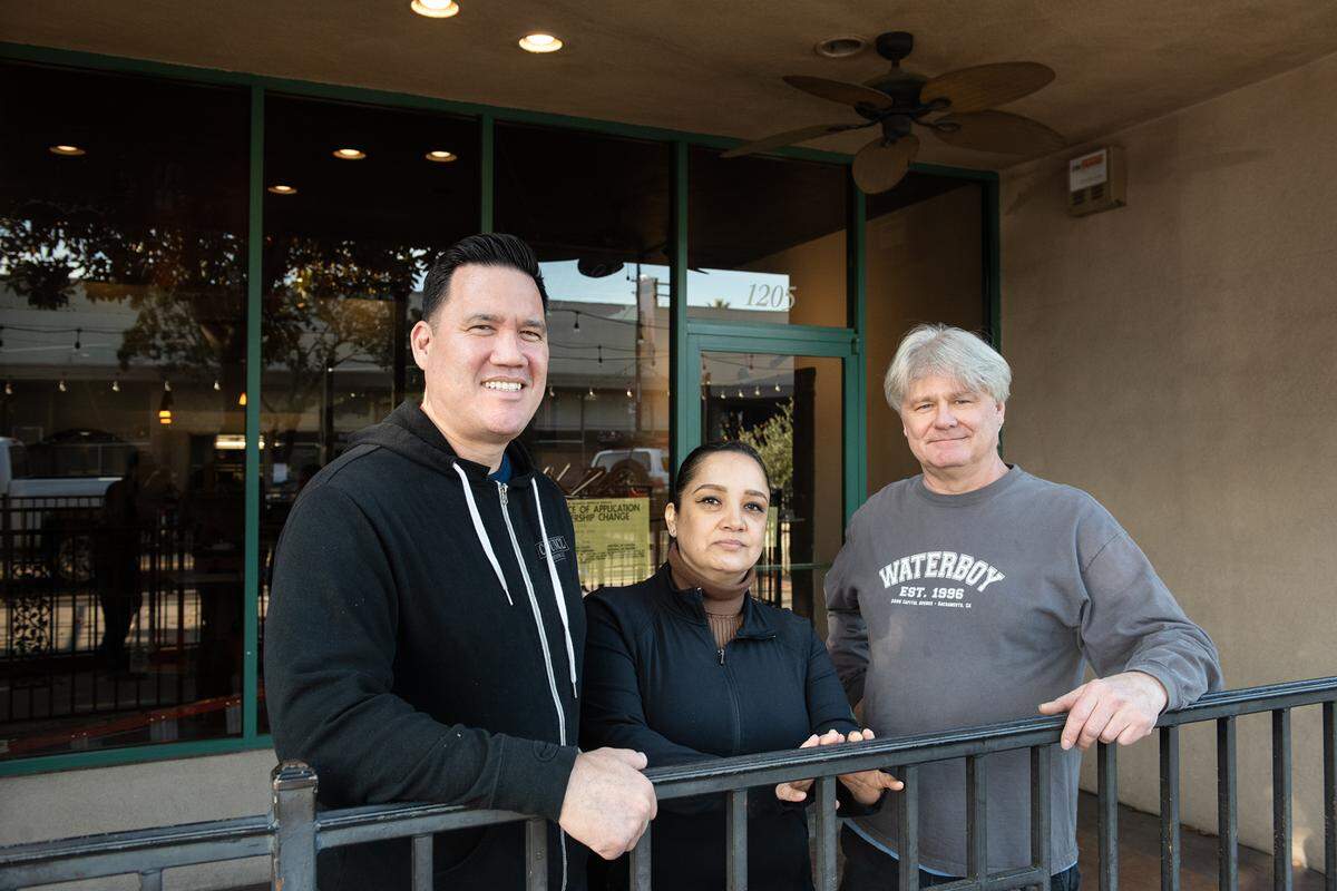 From the left, Patrick Chinn, Sandra Rios, and Paul Tremayne outside the former Concetta space in downtown Modesto, Calif., Friday, Dec. 2, 2022.