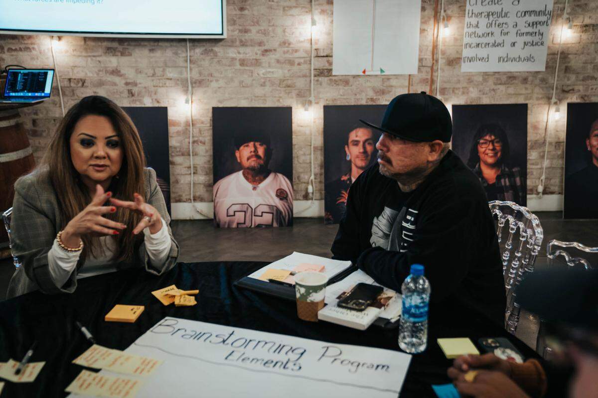 Janet Nunez-Pineda of county Behavioral Health and Recovery Services and Sammy Provencio share a table at a recent planning session for the Homeboy Industries-inspired program for Stanislaus County.