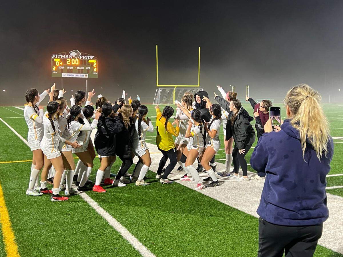 Gregori girls soccer players celebrate their 2-0 CCAL victory over Pitman with a picture of them pointing at the scoreboard. The Jaguars take over first place in the league with the win.