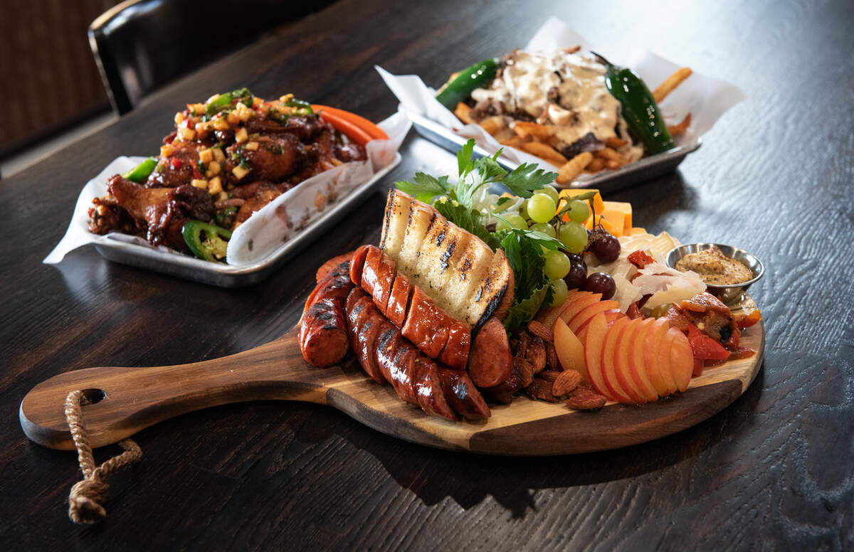 Sausage party platter, with Maui wings, and brew fries at Ranch Hand restaurant in Hughson, Calif., on Thursday, July 28, 2022.