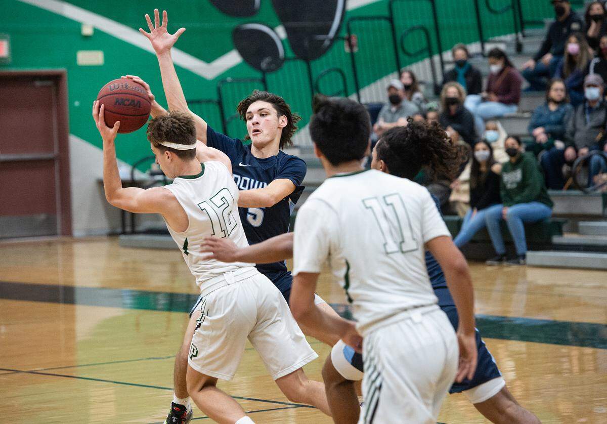 Downey’s David Jones (5) pressures Pitman’s Seth Vink during the Central California Athletic League game at Pitman High School in Turlock, Calif., on Friday, Feb. 4, 2022.
