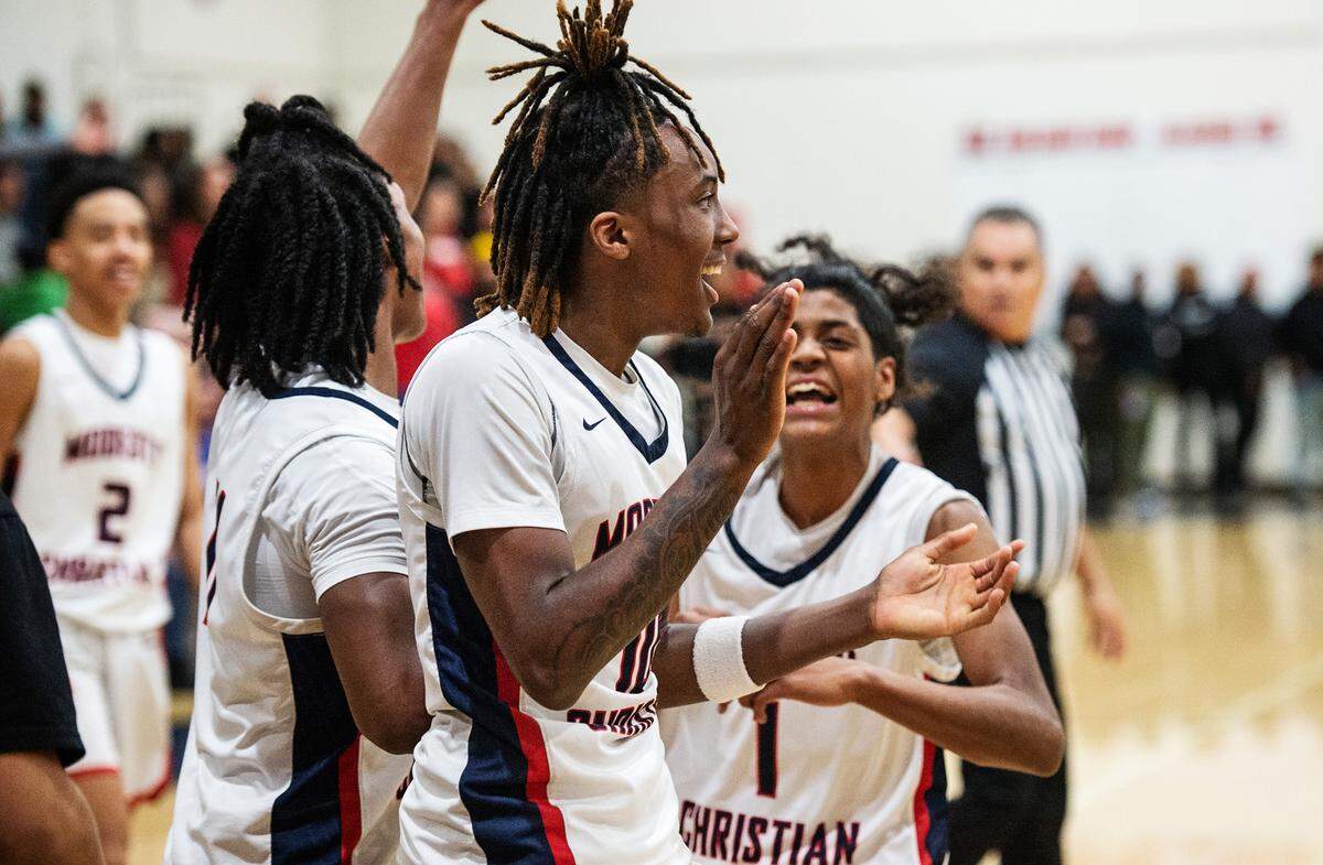 Modesto Christian’s BJ Davis and his teammates celebrate a comeback victory over Lincoln during the Sac-Joaquin Section Division I playoff game with Lincoln at Modesto Christian High School in Salida, Calif., Friday, Feb. 17, 2023.