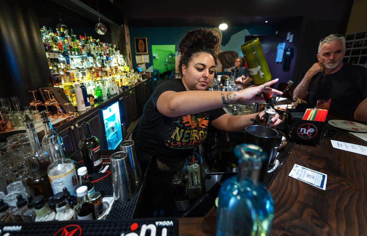 Head bartender Roni Zimmerman mixes drinks at Lo-Fi Laboratories artisan cocktail lounge in Modesto, Calif., Wednesday, Aug. 23, 2023.