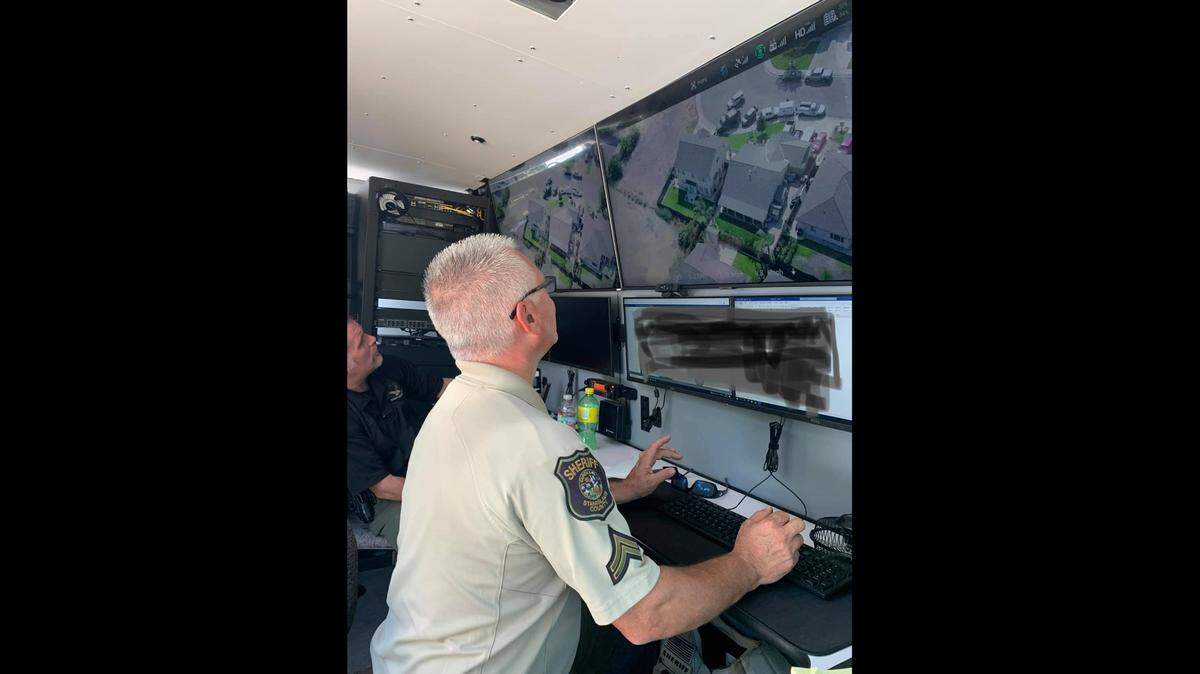 Stanislaus County Sheriff’s Deputies monitor aerial footage of a home where a homicide suspect was arrested Monday, Aug. 23, 2021.