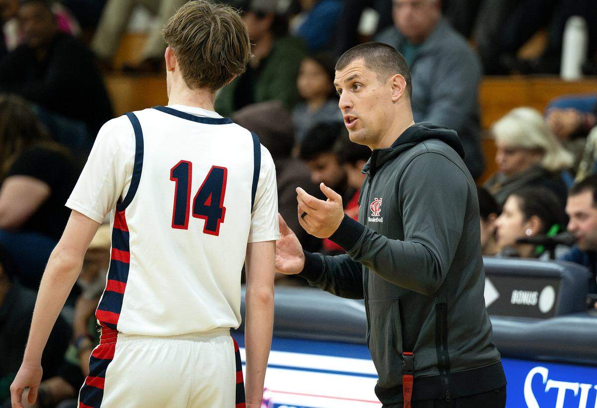Modesto Christian’s coach Brice Fantazia talks with Elijah Payne during the Sac-Joaquin Section Division I playoff game with Pitman at Modesto Christian High School in Salida on Wednesday, Feb. 19, 2025.