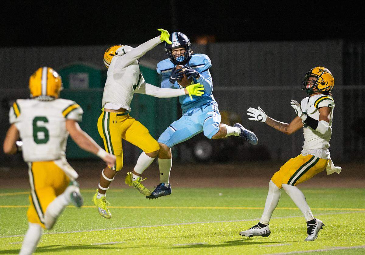 Downey’s Camden Rush makes a touchdown reception surrounded by Tracy defenders during the nonleague game at Downey High School in Modesto, Calif., on Friday, September 16, 2022.