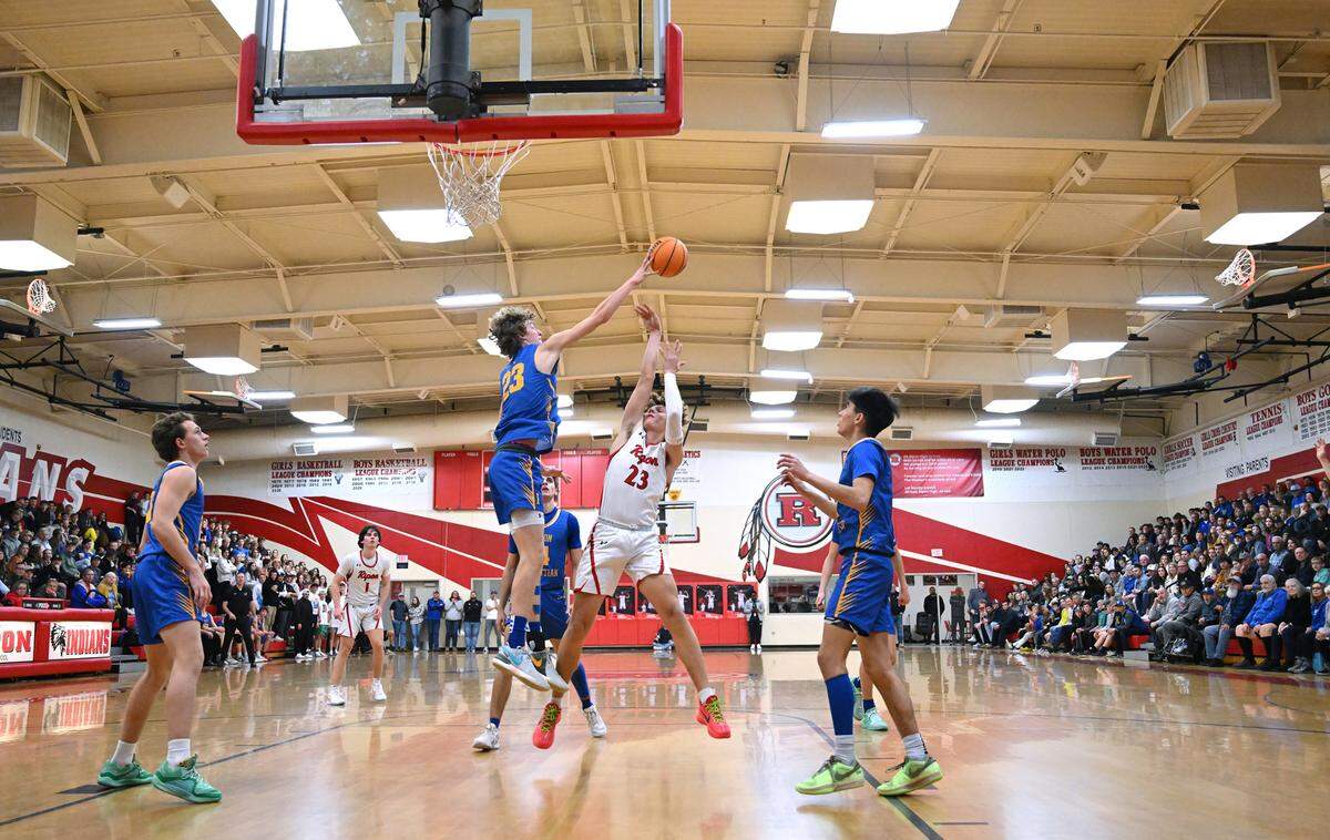 Ripon Christian’s Jace Beidleman blocks the shot of Ripon’s Dawson Downs during the Trans Valley League game in Ripon, Calif., Friday, Feb. 9, 2024.