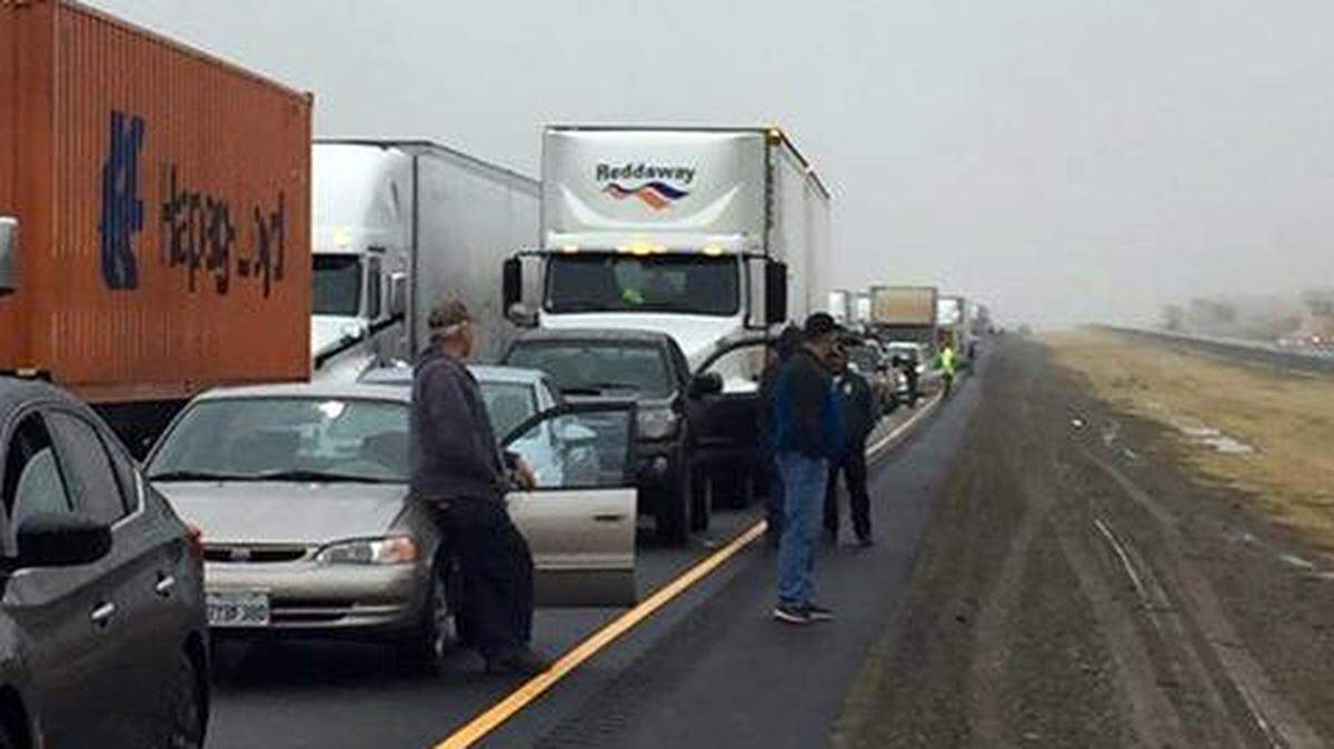 People are out of their cars Tuesday morning, January 9, 2018, on Interstate 5 near Vernalis, Calif., after an early morning fatal crash involving two big rigs and six cars.