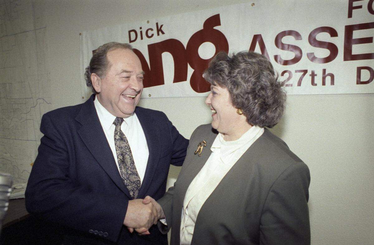 Dick Lang and Carol Whiteside shake hands at lang’s headquarters off McHenry Ave just after a press conference, December 6, 1989.