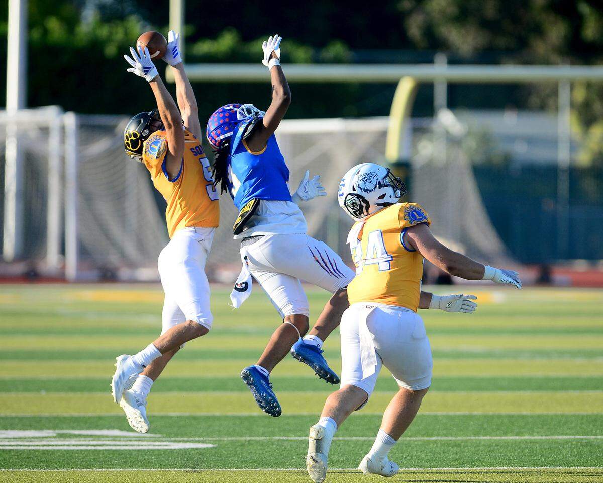 Hughson’s Larkin Meyer (5) deflects a pass intended for Kimball’s Noah Reffell (5) during the 2024 Lions All-Star High School Football game at Tracy High School in Tracy, Calif. on June 22, 2024.