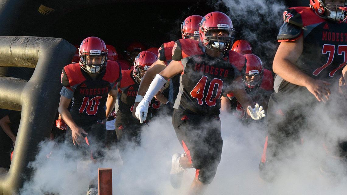 The Modesto High varsity football team takes to the field in 2019.