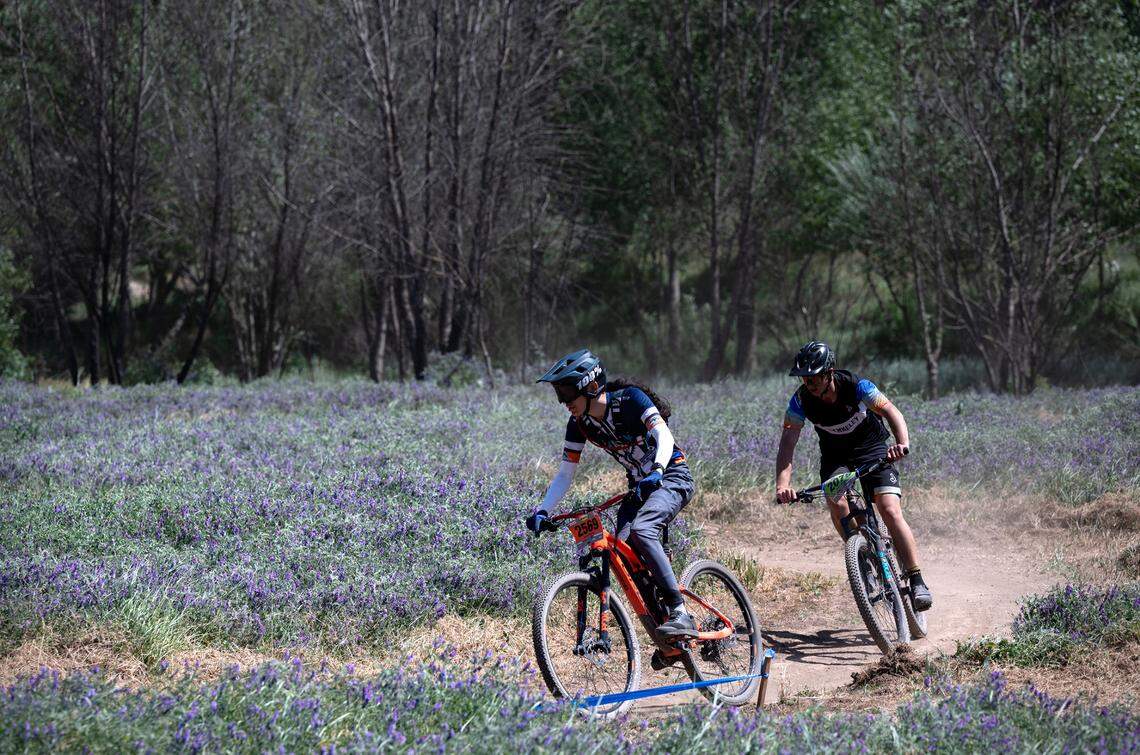 Modesto Composite rider Jaiden Ramiro, left, competes in the boys junior varsity division II race during the NorCal Interscholastic Cycling League event at the Tuolumne River Regional Park in Modesto, Calif., on Saturday, April 9, 2022.
