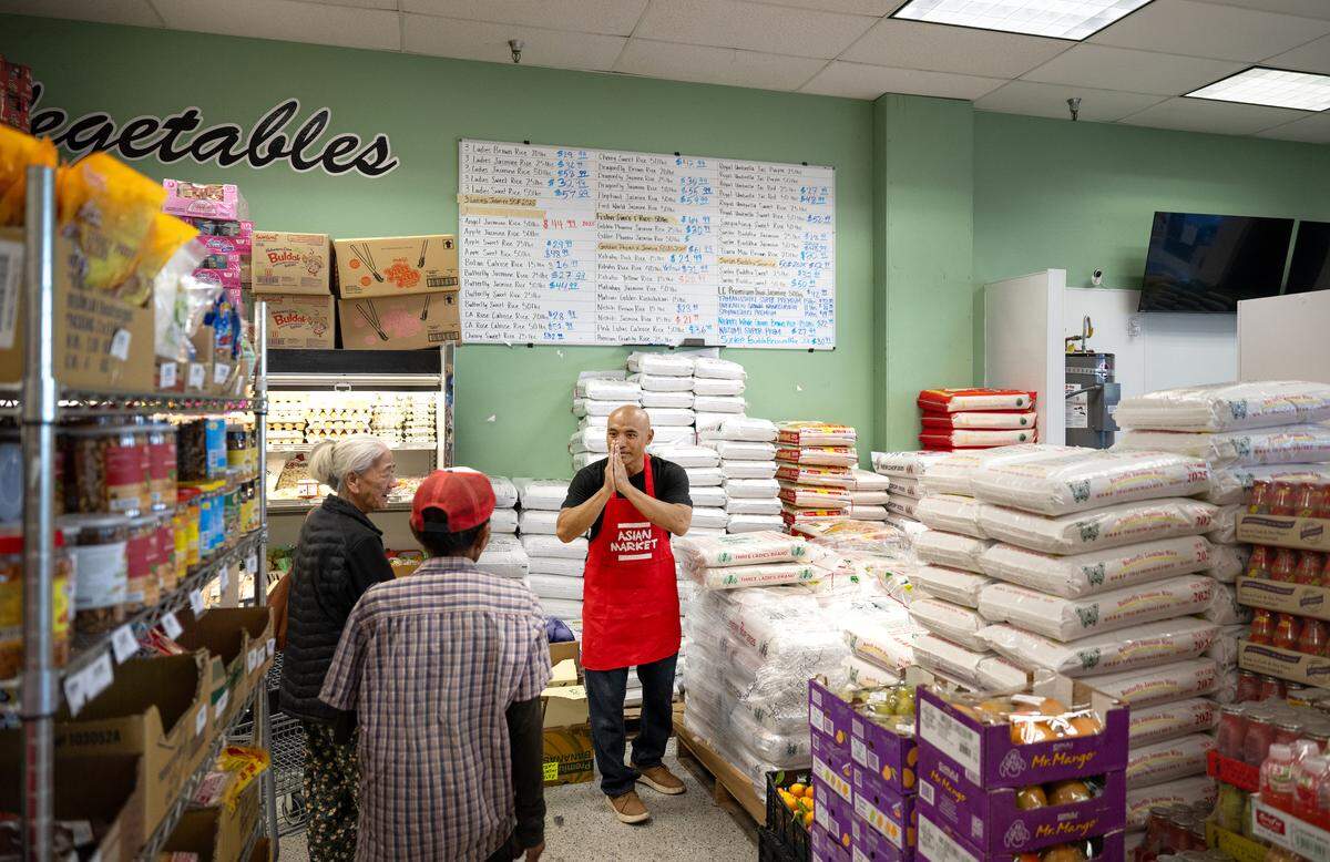 Asian Market clerk Sao Khaoone greets customers at the McHenry Avenue market in Modesto, Wednesday, July 2, 2025.