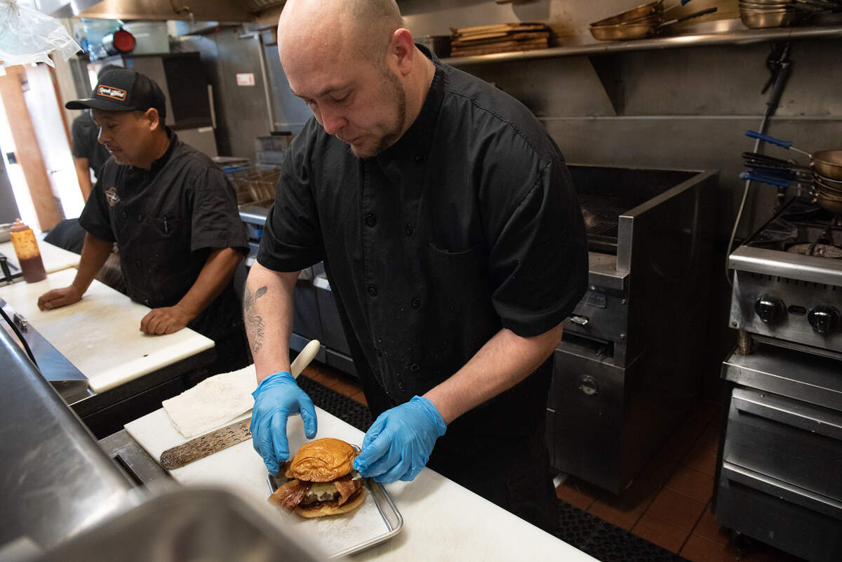 Cook Jason Broyvon prepares the Vaquero burger at Ranch Hand restaurant in Hughson, Calif., on Thursday, July 28, 2022.