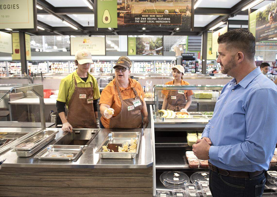 Store director Jerald Smith, right, looks over the custom cuts counter at the Save Mart supermarket on Oakdale Road in Modesto, Calif., Thursday, Sept. 27, 2019.