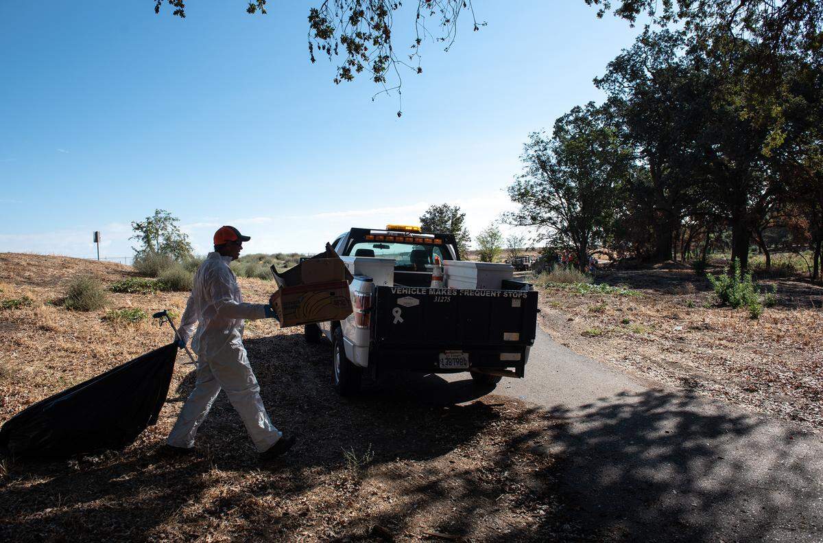 City of Modesto crew members clean up the Tuolumne River Regional Park in Modesto, Calif., on Wednesday, September 21, 2022.