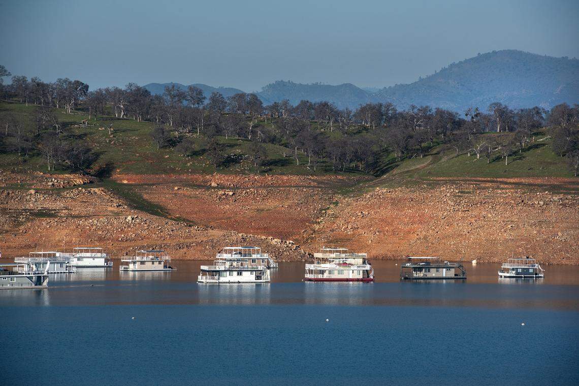 Houseboats sit on the water at Don Pedro Reservoir in Tuolumne County Calif., on Wednesday, Jan. 26, 2022.