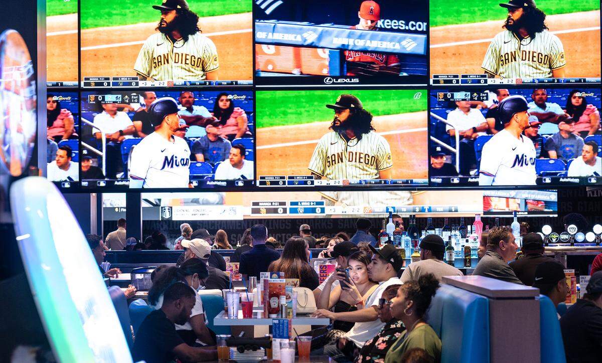 People enjoy eating and drinking with many screens for viewing at Dave & Buster’s entertainment center and restaurant at Vintage Faire Mall in Modesto, Calif., on Thursday, June 2, 2022.