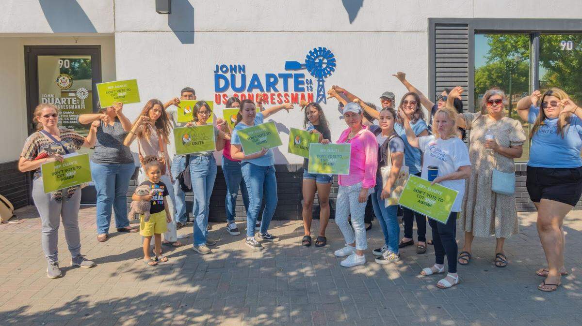 A delegation from CNC Action Fund, CARA and Valley Families Unite stands outside of Rep. Duarte’s Turlock office on Jul. 10, 2024.