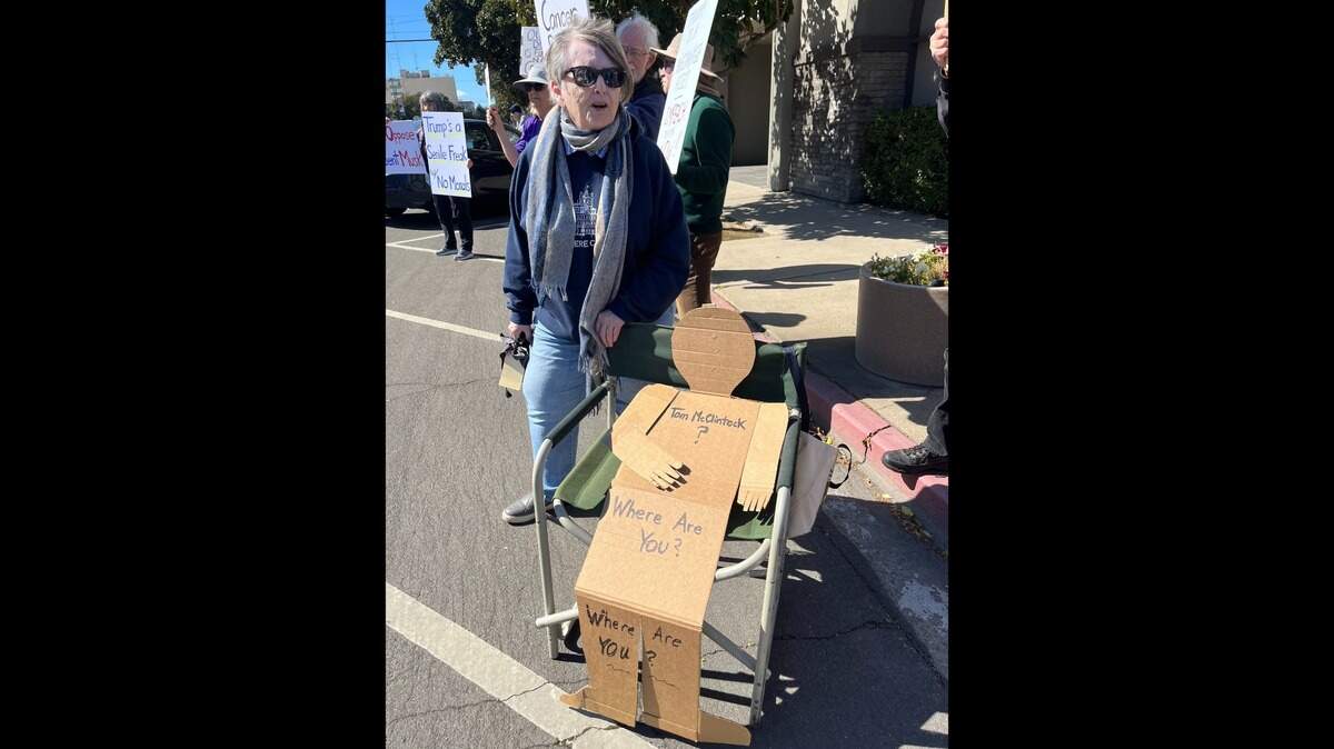 Donna Endsley of Turlock protested with a cardboard cutout of a person that read “Tom McClintock, where are you?”