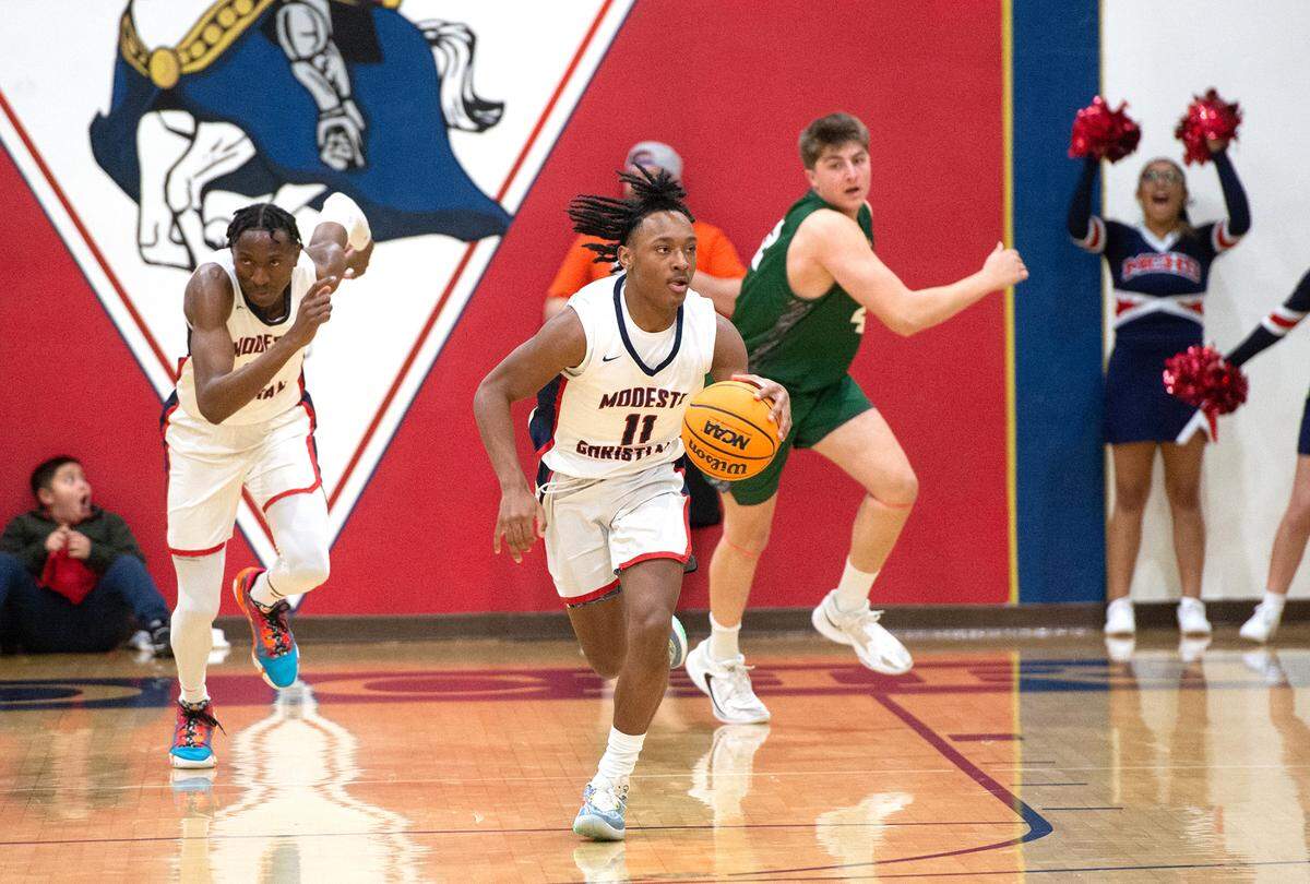 Modesto Christian’s Jeremiah Bernard advances the ball during the NorCal Open Division semifinal playoff game with De La Salle in Salida, Calif., Saturday, March 4, 2023.