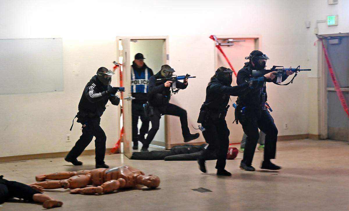 Modesto Police officers storm a room as they participate in active shooter training in Modesto, Calif., Wednesday, Feb. 15, 2023.