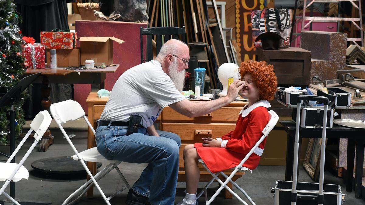 Erin Rieger, (Annie) smiles as she gets her make up applied by Vance Whitaker. The two prepare for the Modesto Performing Arts production of Annie on Tuesday afternoon June 11, 2019.