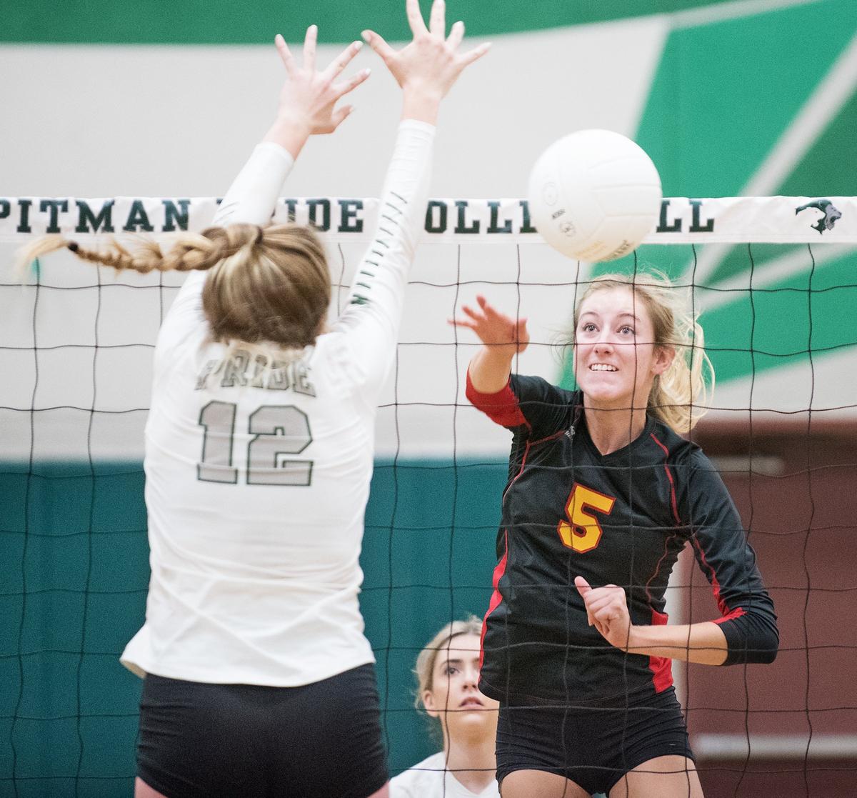 Oakdale’s Grace Verdegaal (5) spikes the ball past Pitman’s Madison King (12) during Thursday’s match at Pitman High School n Turlock, Calif., August 30, 2018.