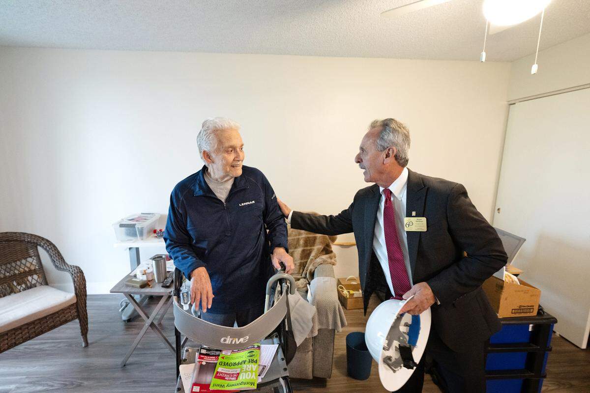 Resident Rudy Rocha, 86, left, talks with Retirement Housing Foundation CEO Stuart Hartman at Marple Manor senior housing complex in Modesto, Calif., Friday, Nov. 17, 2023. The complex is undergoing a major renovation, the 145 apartment units are getting a makeover with updated kitchens and bathrooms, new cabinets, flooring, appliances, ceiling fans and window blinds. Rocha’s fifth floor apartment has recently been completed.