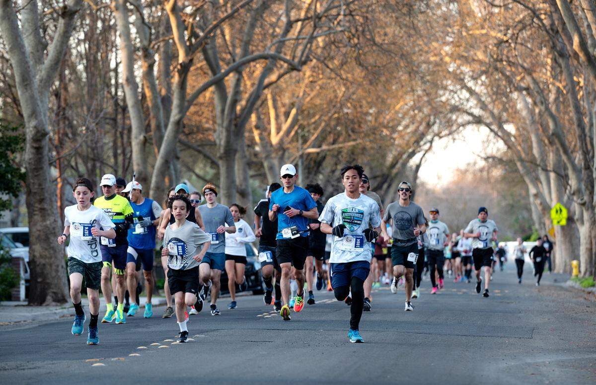 Participants run down Sycamore Avenue during the Modesto Marathon in Modesto, Calif., Sunday, March 26, 2023. In addition to the marathon, runners participated in half-marathon, 10k and 5k races.