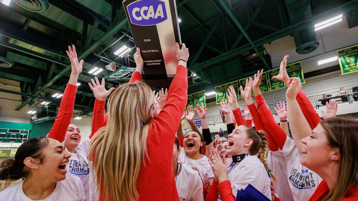The Stanislaus State women’s volleyball team (22-7, 12-6 CCAA) celebrates with the CCAA trophy after winning the program’s first ever CCAA tournament, beating Cal State LA 3-1 on Nov. 23, 2024. The Warriors will participate in the NCAA Division II National Tournament as the No. 6 seed in the West Region.