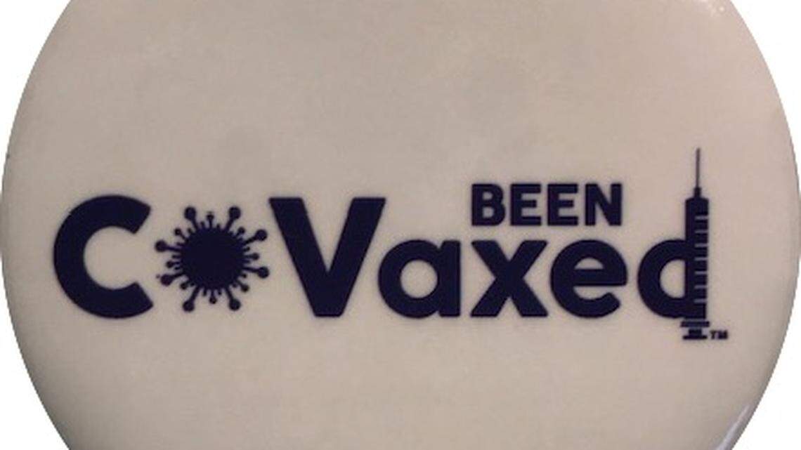 A lapel pin with Curtis Lineberger’s Been CoVaxed logo. He hopes his t-shirts, ball caps, wrist bands and stickers will persuade people to get COVID-19 vaccines.
