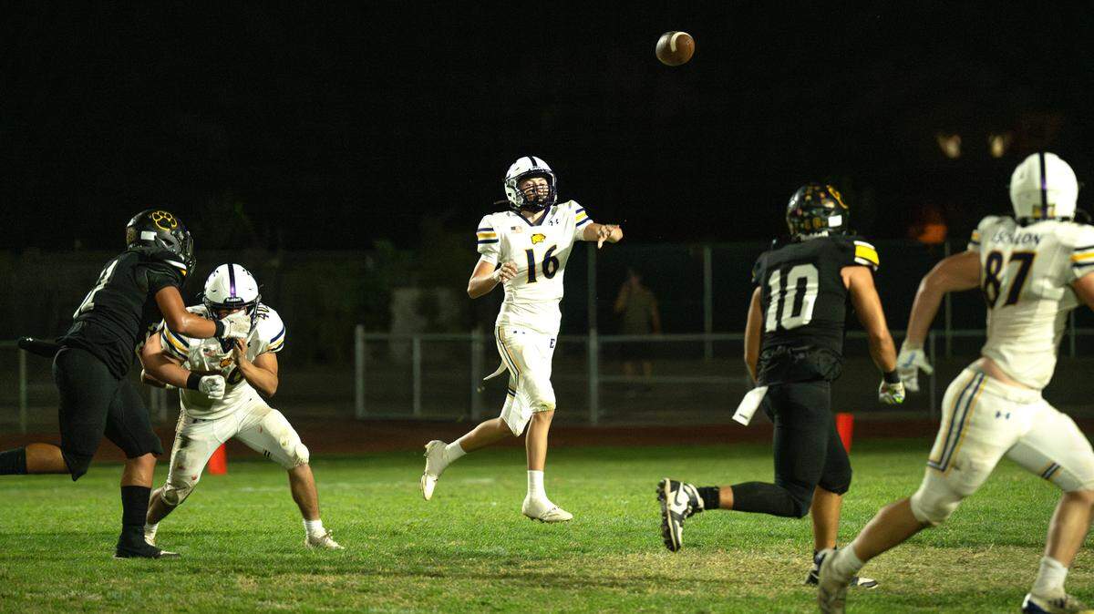 Escalon quarterback Donovan Martinez makes a pass to Ryan Lewis (87) during the Trans Valley League game with Hughson in Hughson, Calif., Friday, Oct. 4, 2024.