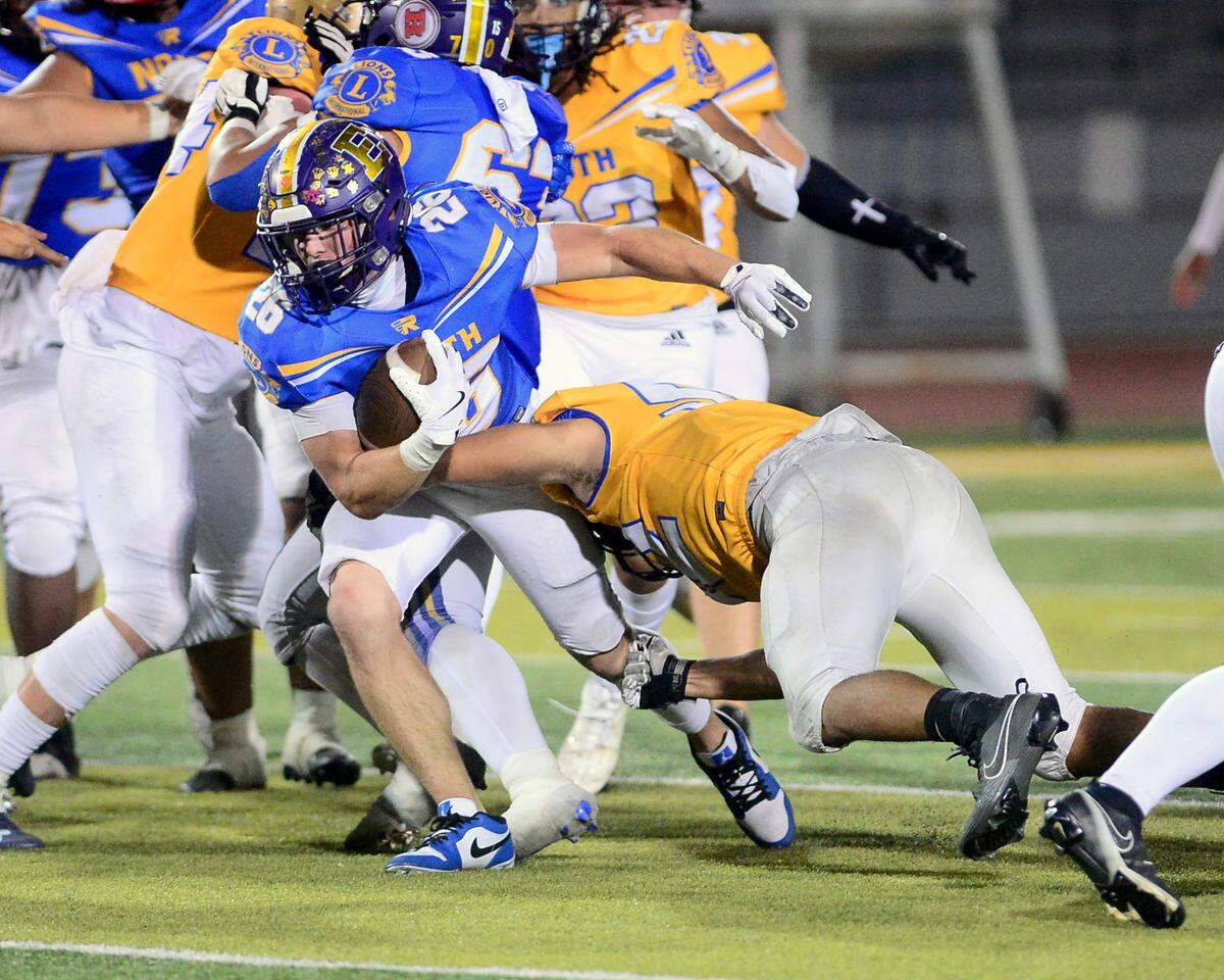 Escalon running back Jamin Miller (26) gets hit by a South team defender during the 2024 Lions All-Star High School Football game at Tracy High School in Tracy, Calif. on June 22, 2024.