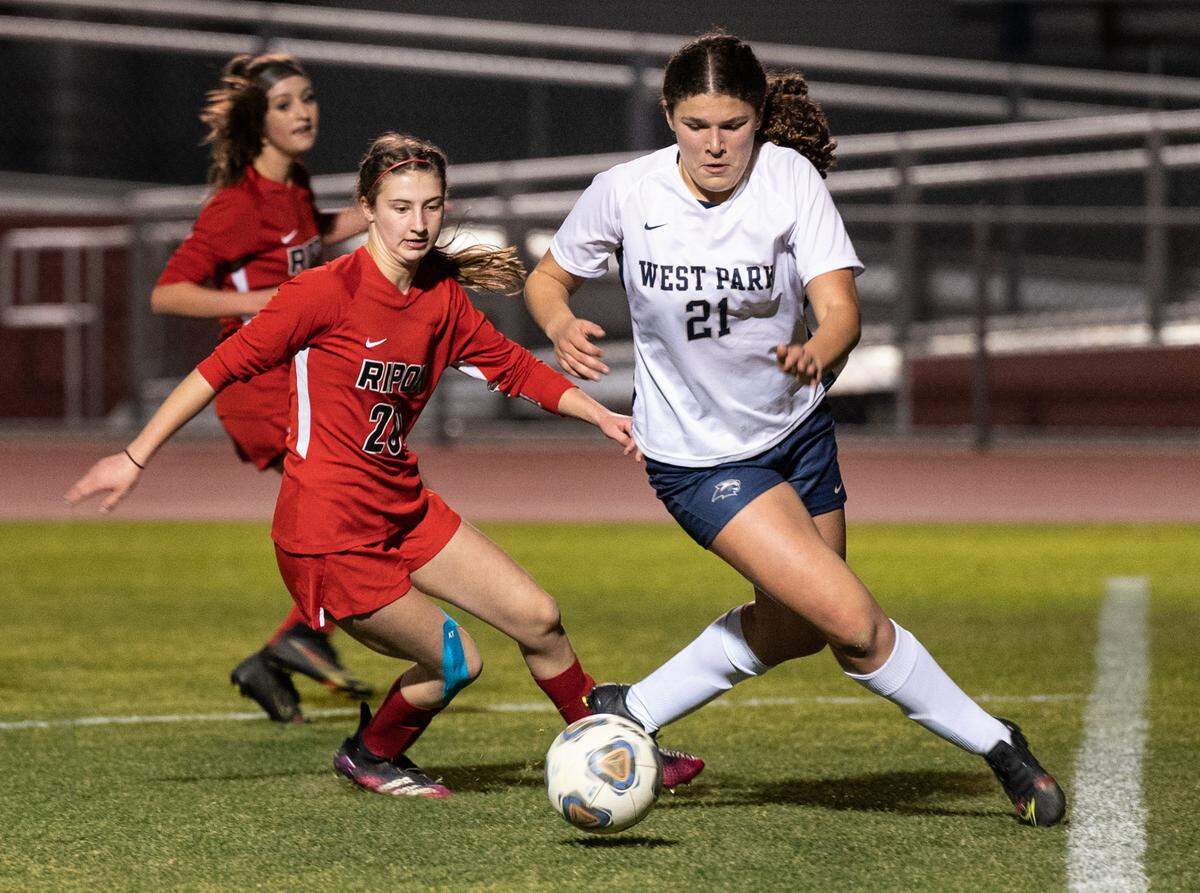 Ripon’s Olivia Maragos, left, and West Park defender Megan Herman play for a loose ball during the Sac Joaquin Section Division V playoff game at Ripon High School in Ripon, Calif., on Wednesday, Feb. 16, 2022.