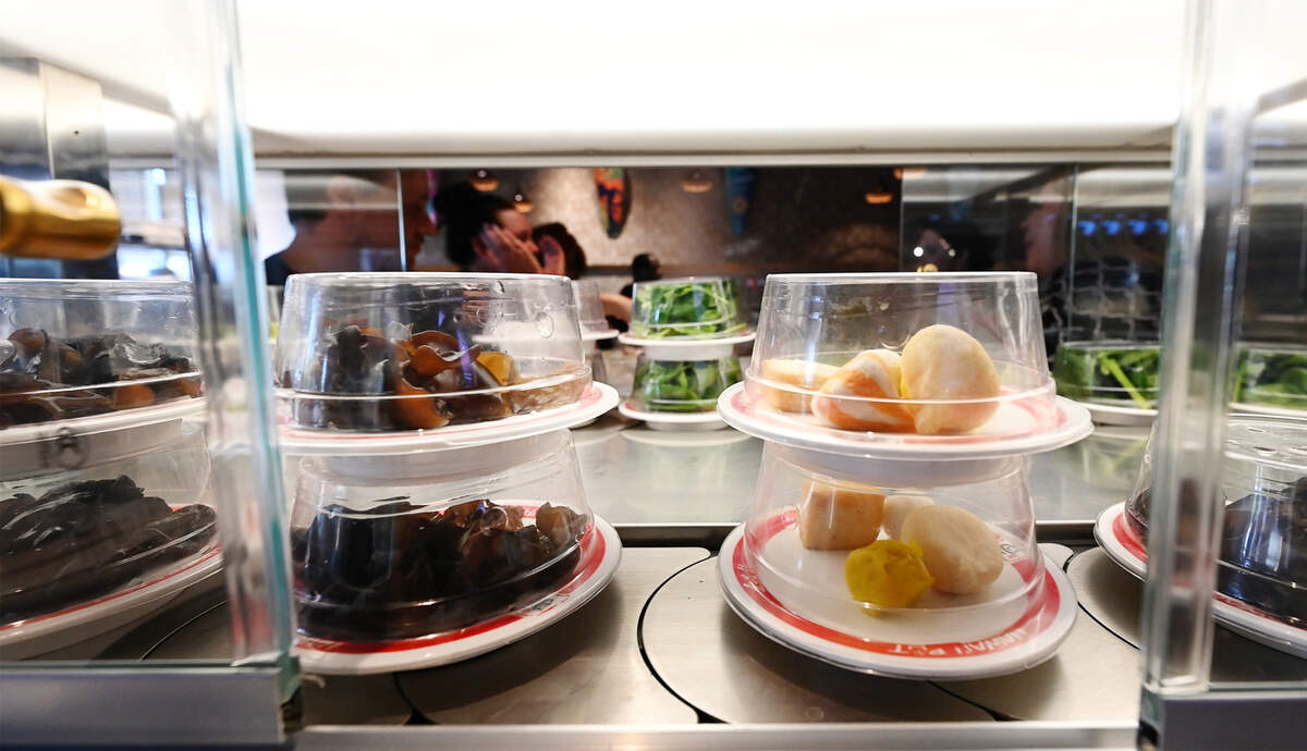 Multiple conveyor belts in the restaurant bring items including various noodles, vegetables, fish cakes, shrimp, sausage, tofu, bok choy, napa cabbage, quail eggs and potstickers to the table at Hawai’i Pot Shabu Shabu House in Modesto, Calif., Tuesday, May 14, 2024.