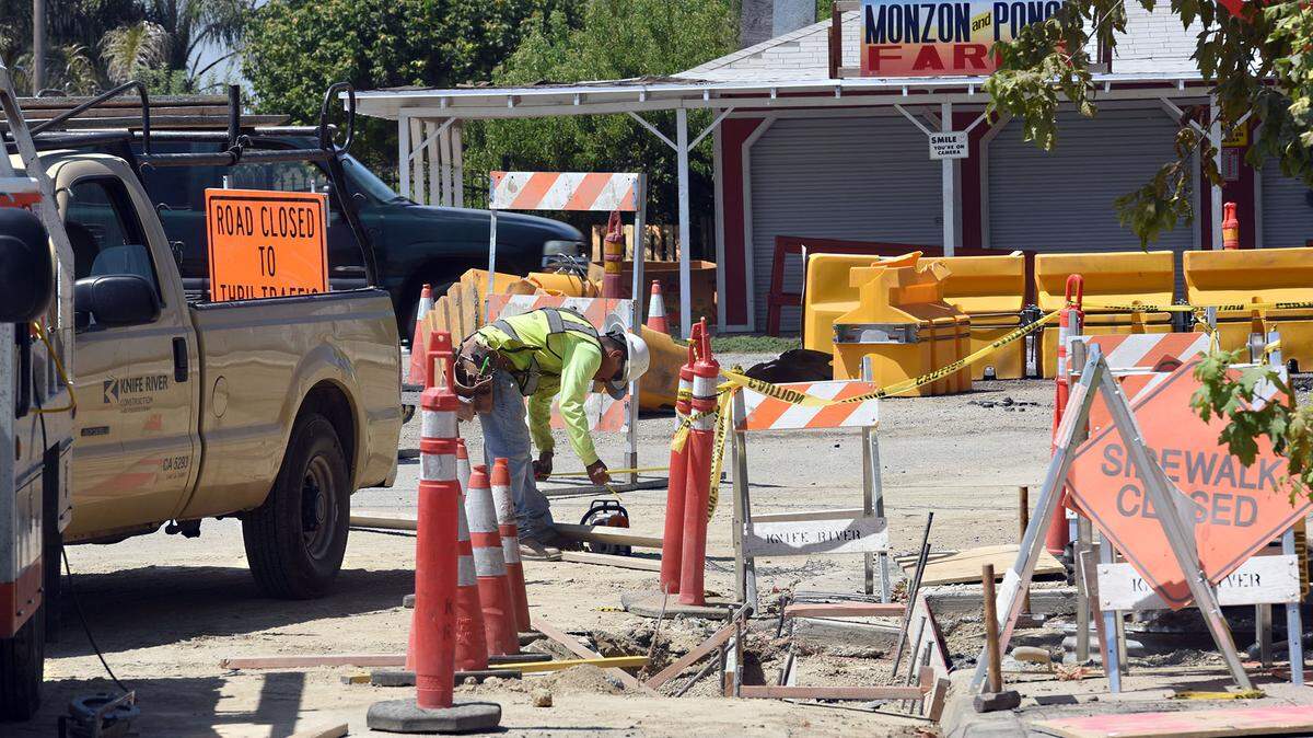 A construction crew with Knife River works on a sidewalk on Chicago avenue at Carpenter road in Modesto, Calif. on Thursday afternoon August 16, 2018.