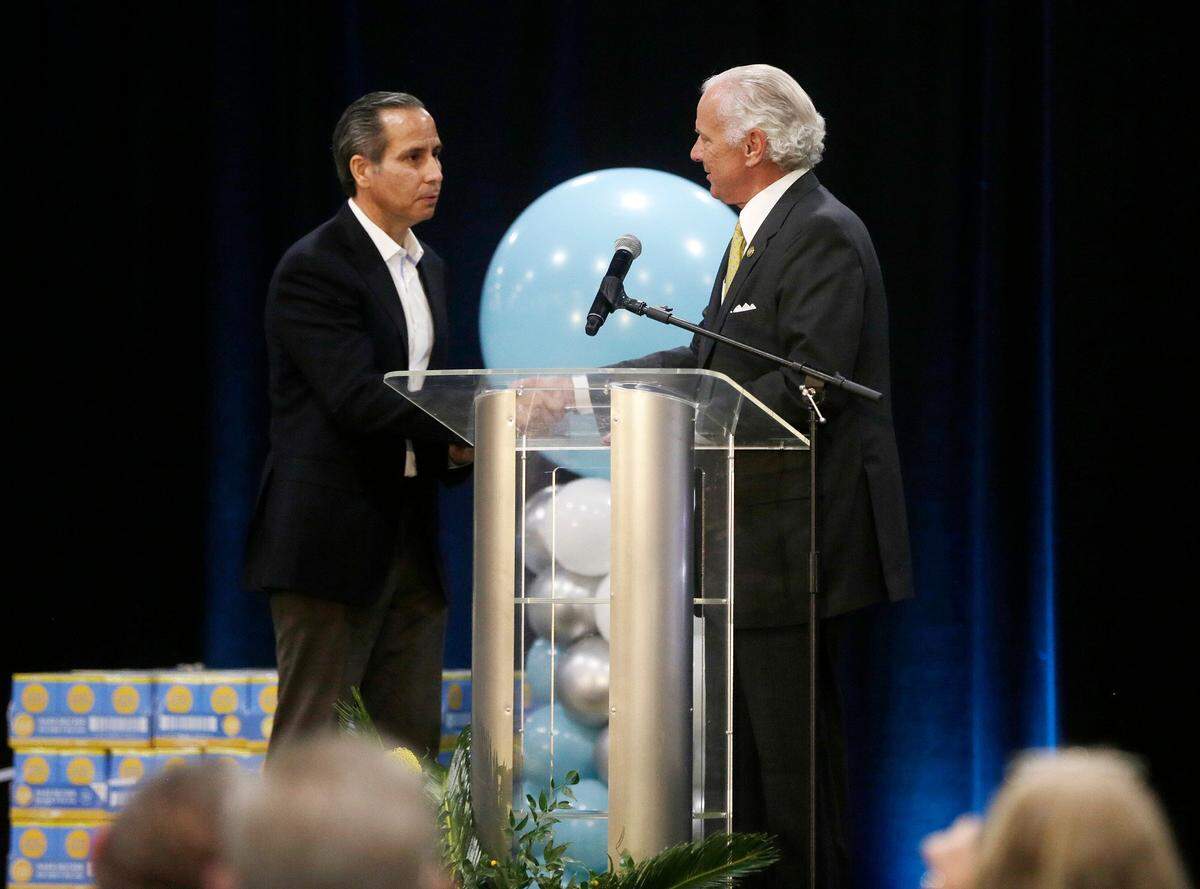 South Carolina Gov. Henry McMaster, right, presents the state flag to E.&J. Gallo Winery CEO Ernest Gallo on Friday, Oct. 14, 2022, at the new Chester County Operations Facility in Fort Lawn, S.C.