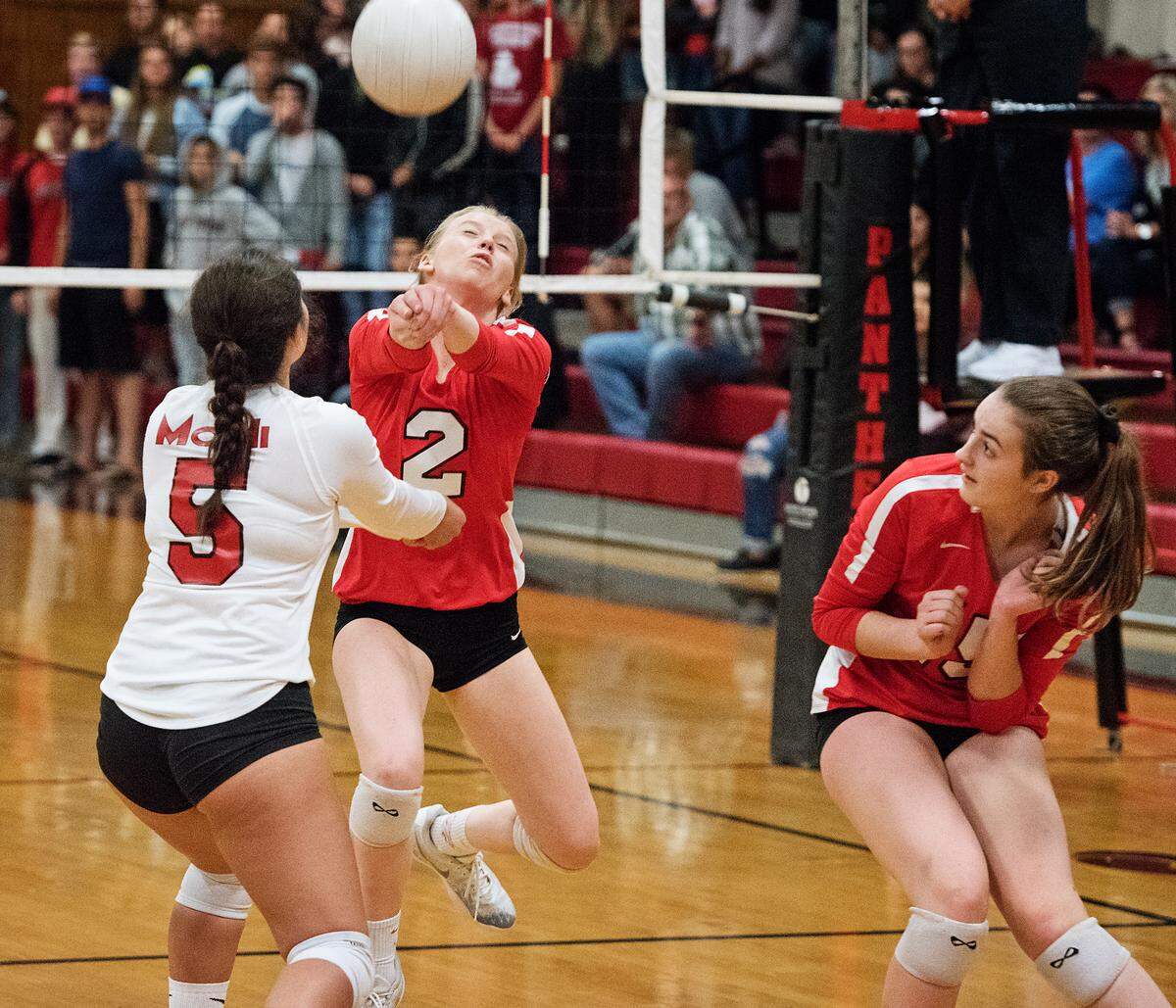Modesto’s Alyssa Cover (2) makes the save between teammates Samantha Delgado (5) and Hannah Scott, right, during the Sac Joaquin Section playoff game with Folsom at Modesto high School in Modesto, Ca., on Tuesday, Oct. 23, 2018.