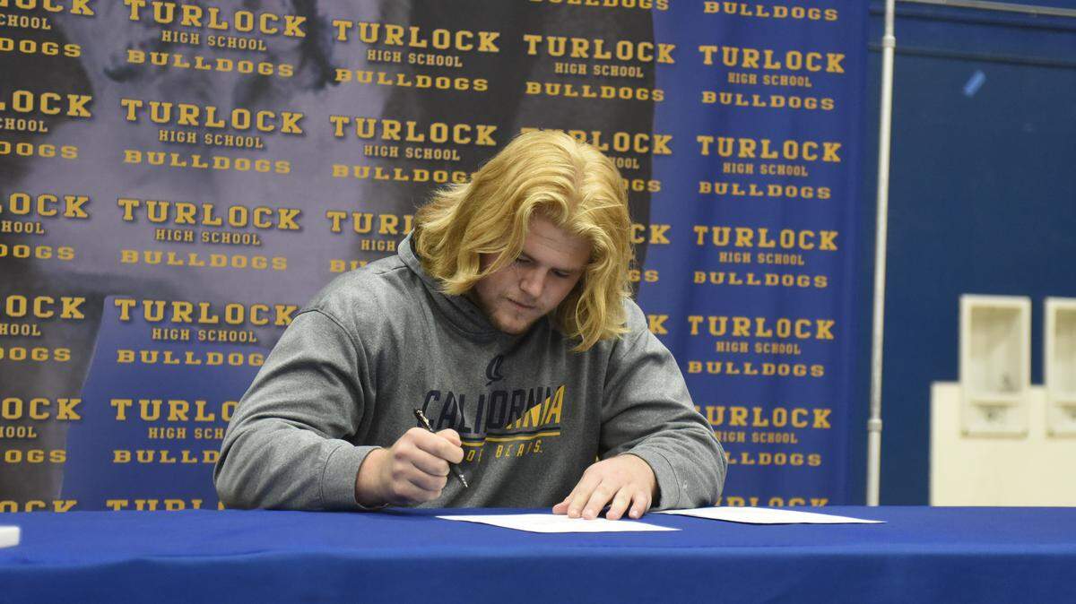 Turlock High School senior offensive lineman Everett Johnson signs his National Letter of Intent with Cal on Wednesday, Dec. 18, 2019 at Turlock High School. Wednesday was the first day high school and JC football players could sign.