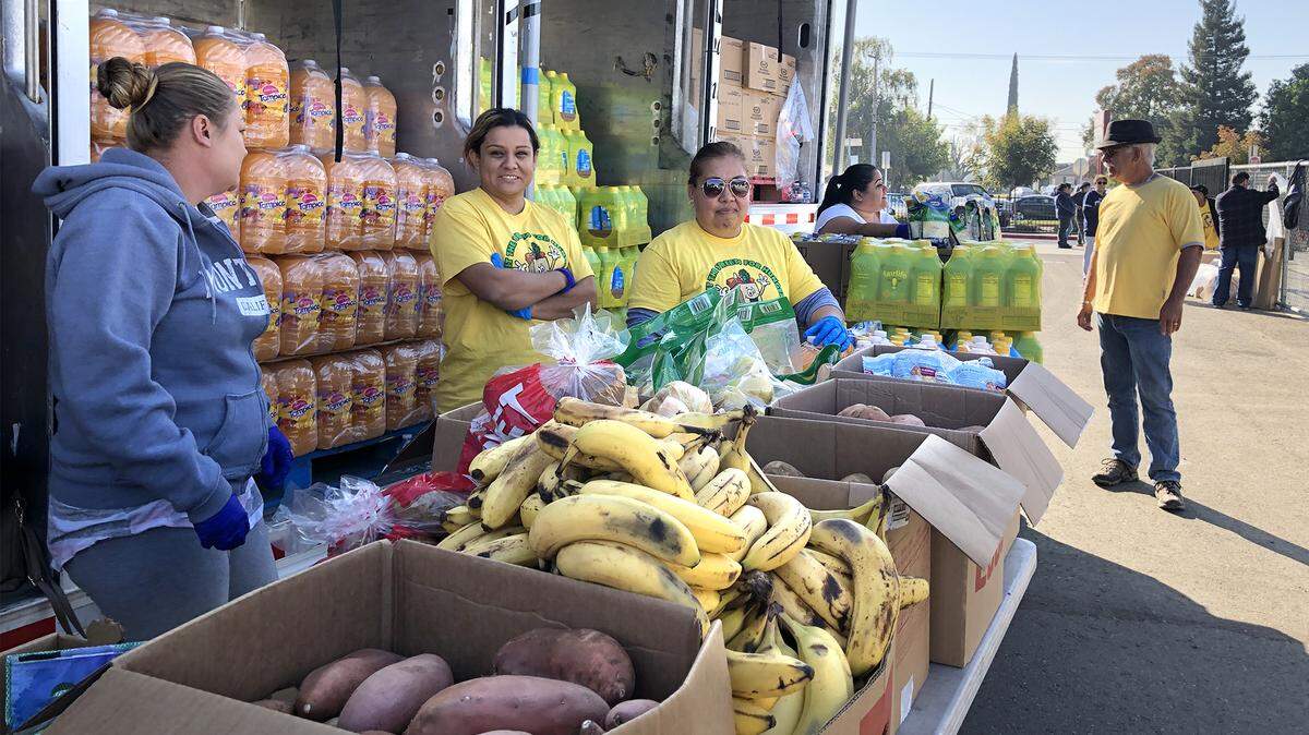 Volunteers prepare to distribute fresh foods at Fowler Elementary School in Ceres, Calif. on Wednesday November 6, 2019.