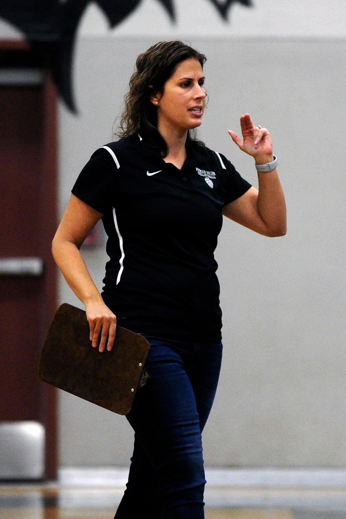 Pitman coach  Kristen Pontes-Christian motions to the bench during the senior night, crosstown volleyball matchup of Turlock High at Pitman High, on Monday, Oct., 15 in Turlock, California.