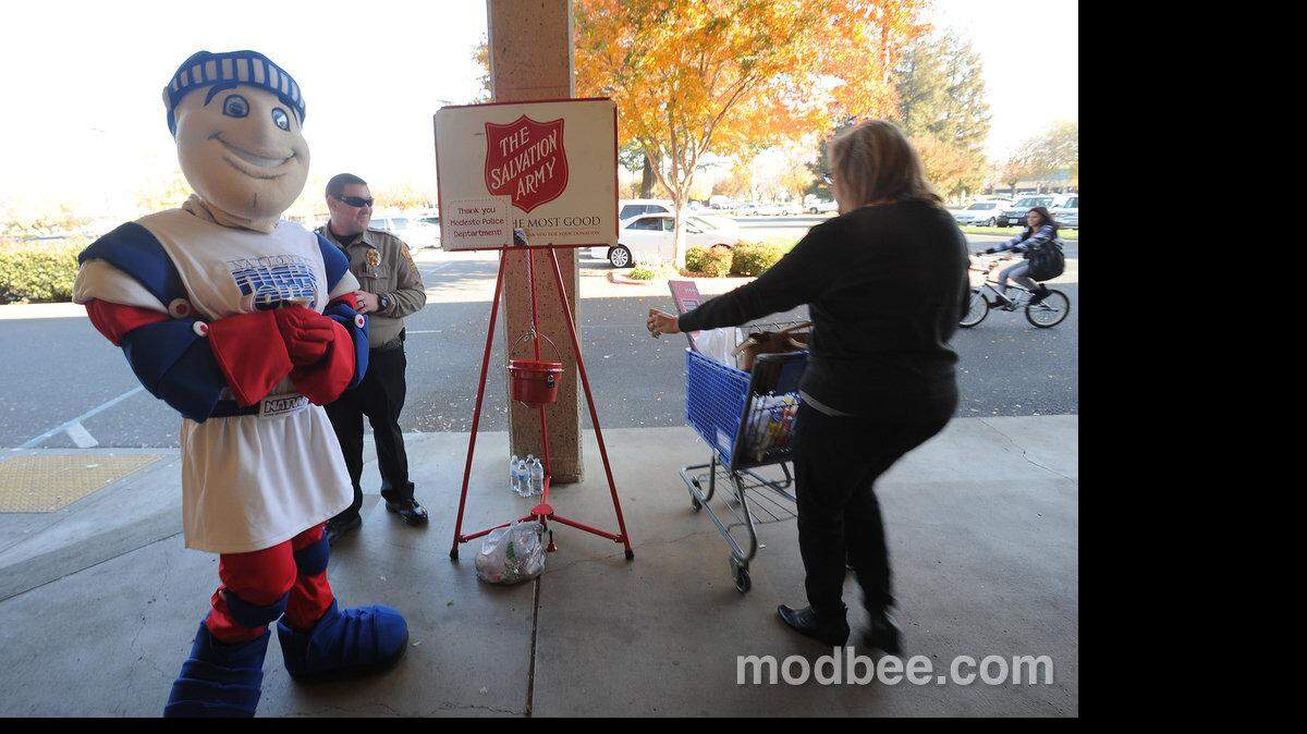 Modesto Police Department's National Night Out Knight rings a Salvation Army bell outside Hobby Lobby on Saturday afternoon.